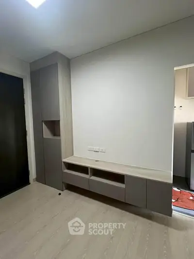 Modern minimalist living room with built-in storage and sleek design