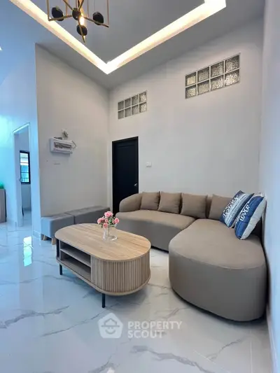 Modern living room with stylish furniture and elegant lighting, perfect for relaxation and entertaining.