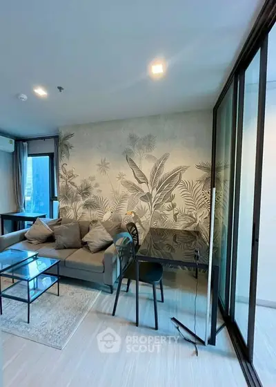 Stylish living room with modern decor and large windows in a contemporary apartment.