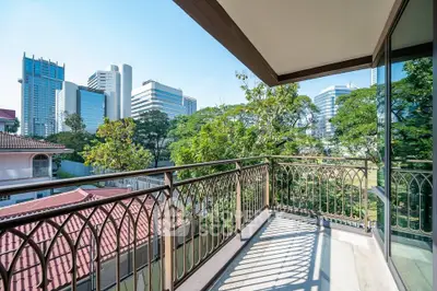 Spacious balcony with city skyline view, perfect for relaxation and enjoying urban living.