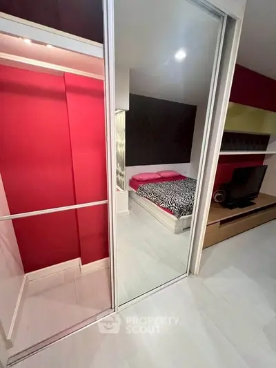 Modern bedroom with stylish decor and mirrored closet doors