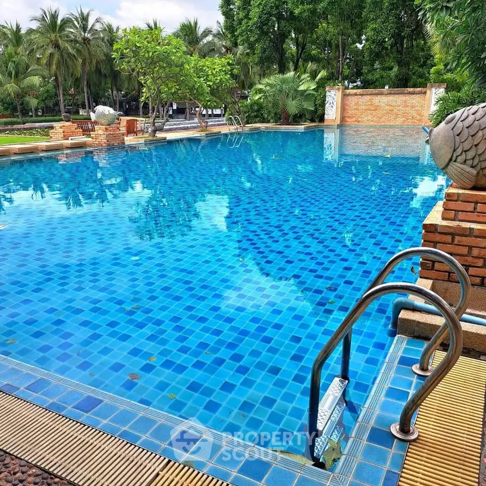 Luxurious outdoor pool with lush greenery and serene ambiance, perfect for relaxation and leisure.