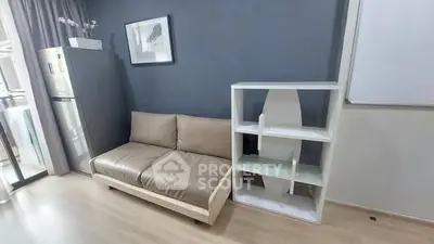 Modern living room with sleek sofa and stylish shelving unit, perfect for urban living.