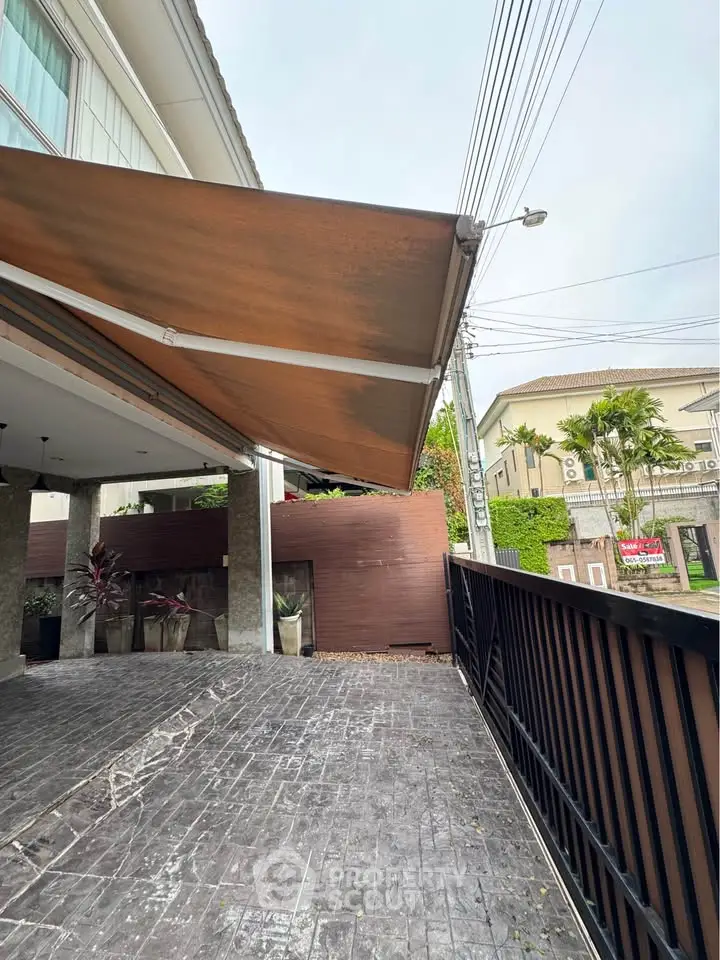 Modern house exterior with stylish awning and spacious driveway