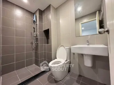Modern bathroom with sleek tiles and contemporary fixtures in a stylish apartment.
