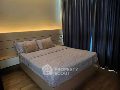 Modern bedroom with cozy lighting and elegant curtains in a stylish apartment.