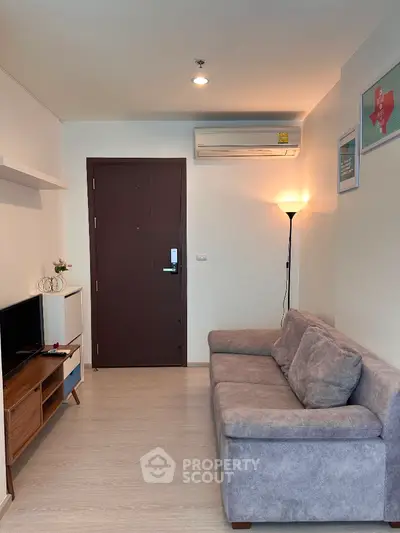 Cozy living room with modern decor and comfortable sofa in a stylish apartment.