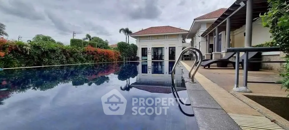 Luxurious villa with stunning pool and lush garden, perfect for relaxation and entertainment.