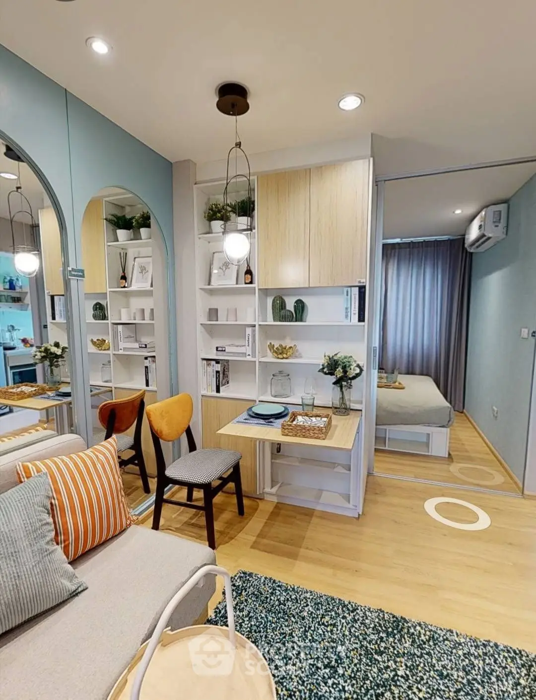 Stylish modern living room with open layout and cozy bedroom view.