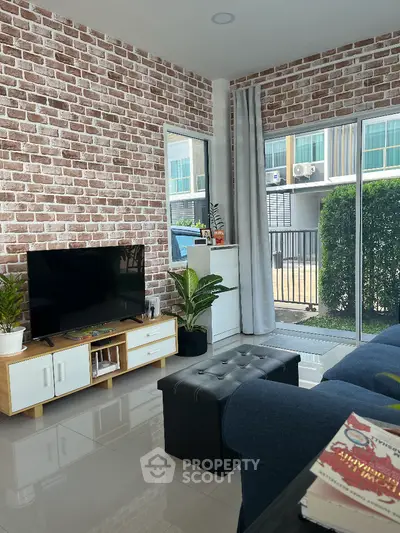 Modern living room with brick accent wall and sleek furniture