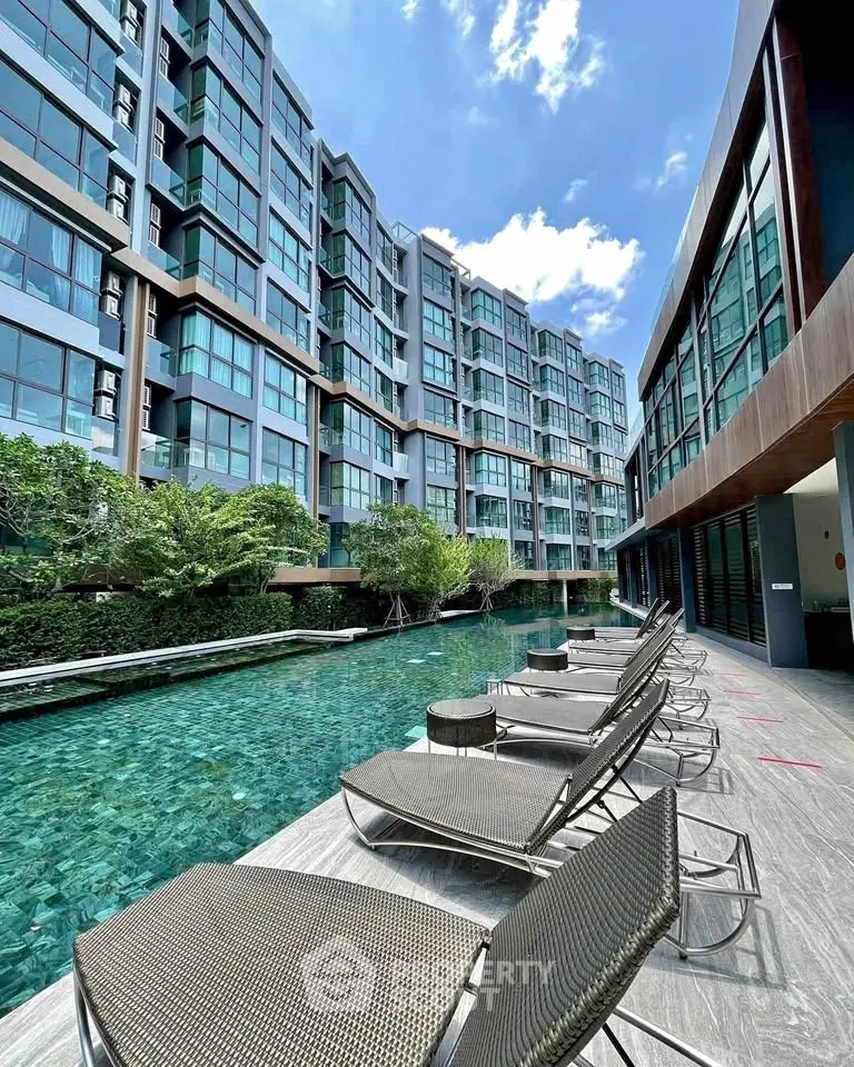 Luxurious condominium with stunning poolside view and modern architecture.