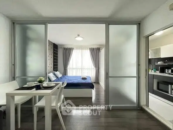 Modern studio apartment with sliding glass doors and stylish decor