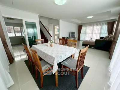 Spacious open-plan living and dining area with modern furniture and natural light.