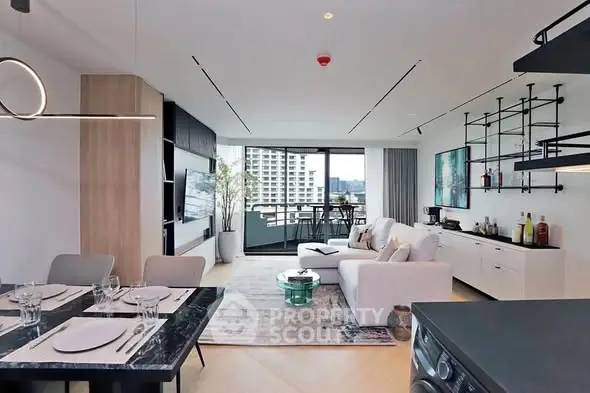 Modern open-plan living room with stylish decor and balcony view in luxury apartment.