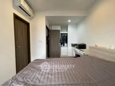 Cozy bedroom with modern air conditioning and built-in wardrobe