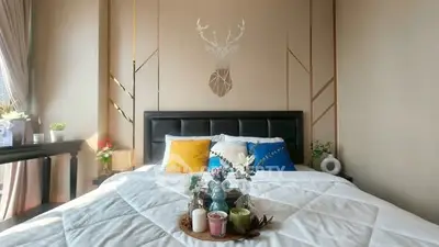 Stylish bedroom with modern decor and cozy bedding, perfect for relaxation.