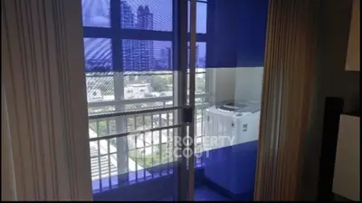 Modern apartment balcony with city view and washing machine