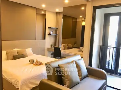 Modern bedroom with balcony access and cozy seating area