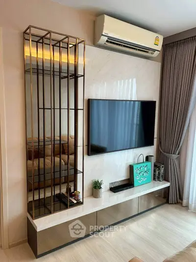 Modern living room with sleek TV unit, air conditioning, and elegant decor.