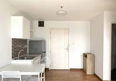 Modern compact kitchen with dining area in a minimalist apartment