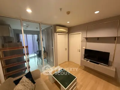 Modern living room with glass partition and cozy seating area