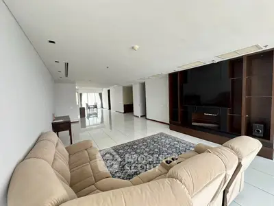 Spacious living room with modern furniture and large TV unit in luxury apartment.