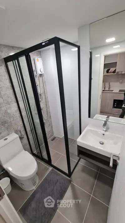 Modern bathroom with sleek shower enclosure and contemporary fixtures.