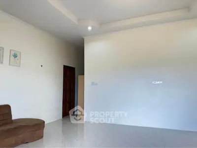 Spacious living room with modern ceiling design and tiled flooring