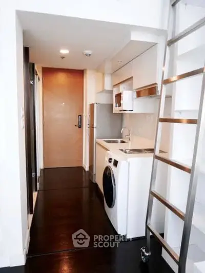 Modern compact kitchen with washing machine and sleek design in urban apartment