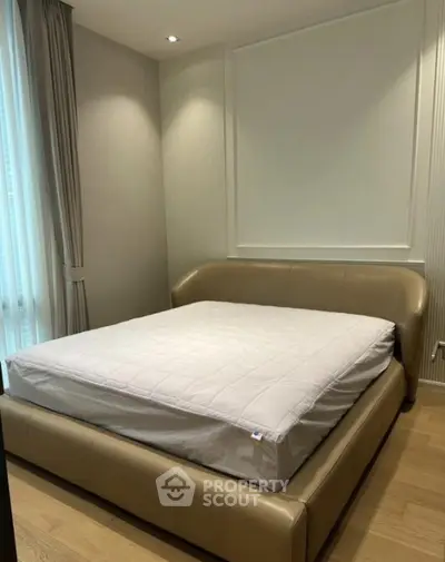 Modern bedroom with stylish leather bed and soft lighting