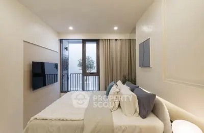 Modern bedroom with balcony access and stylish decor in a contemporary apartment.