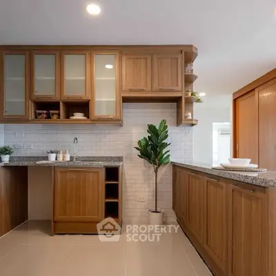 Modern kitchen with wooden cabinets and granite countertops in a stylish home.