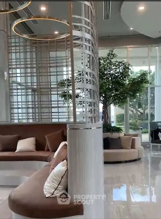 Luxurious modern lobby with elegant seating and greenery, perfect for upscale living.