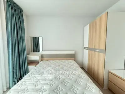 Modern bedroom with stylish wardrobe and elegant curtains in a bright apartment.