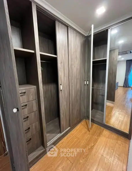 Spacious walk-in closet with wooden finish and ample storage space