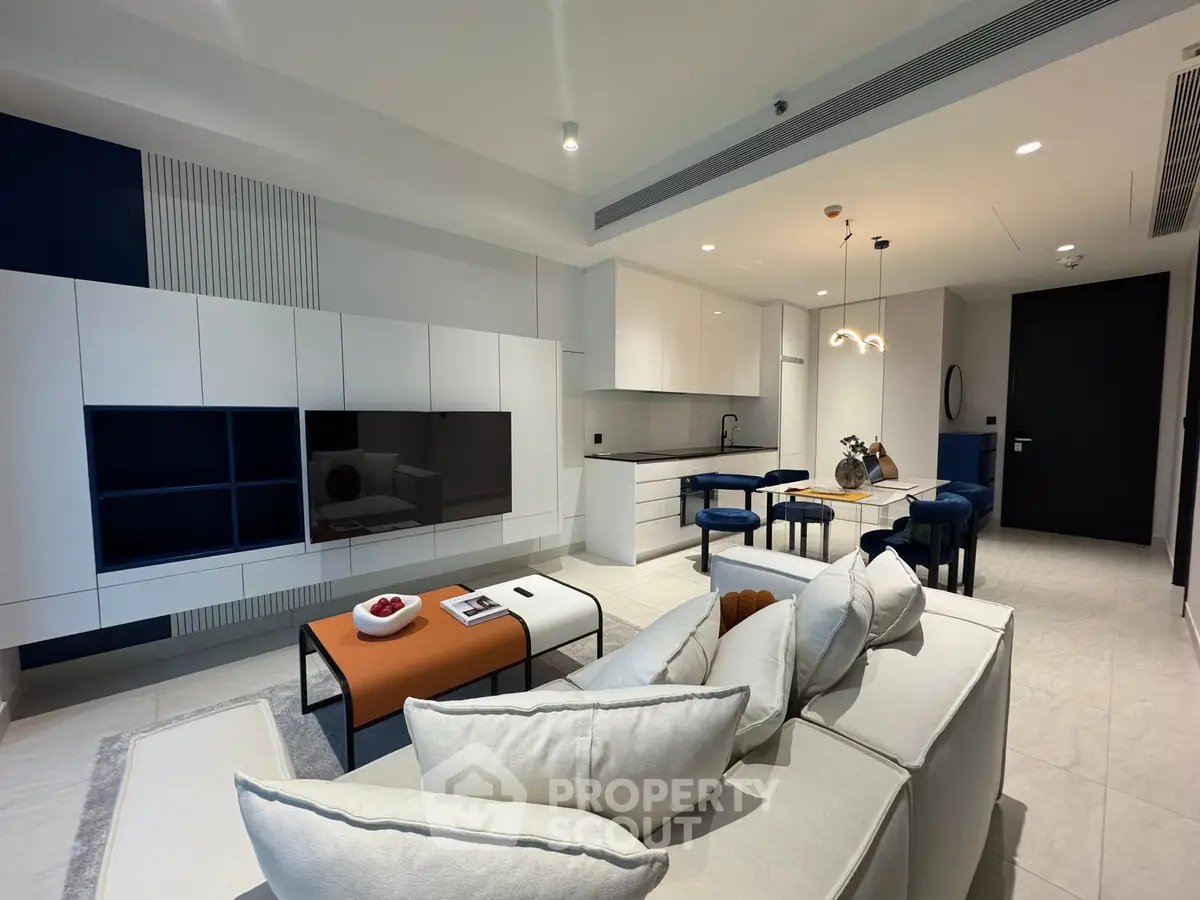 Modern open-plan living room with sleek kitchen and stylish decor