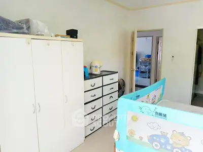 Spacious bedroom with ample storage and playful decor, perfect for a family home.