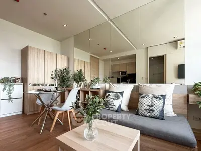Modern living room with stylish decor and open layout, featuring cozy seating and dining area.
