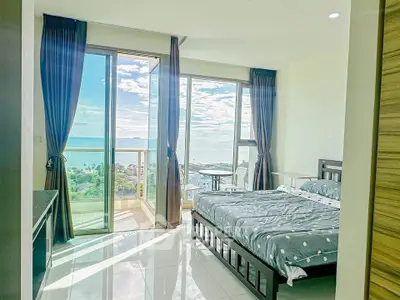 Stunning bedroom with ocean view and balcony access in modern apartment