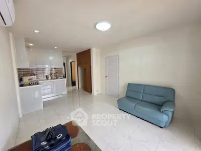 Spacious living room with modern kitchen in open layout apartment