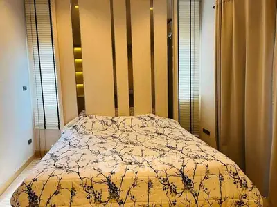 Cozy bedroom with elegant decor and floral bedding in modern apartment.