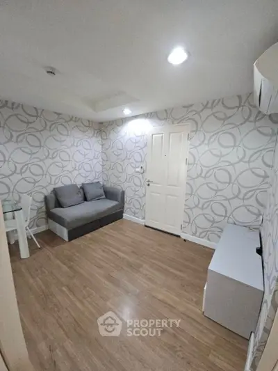 Modern living room with stylish wallpaper and cozy seating area.