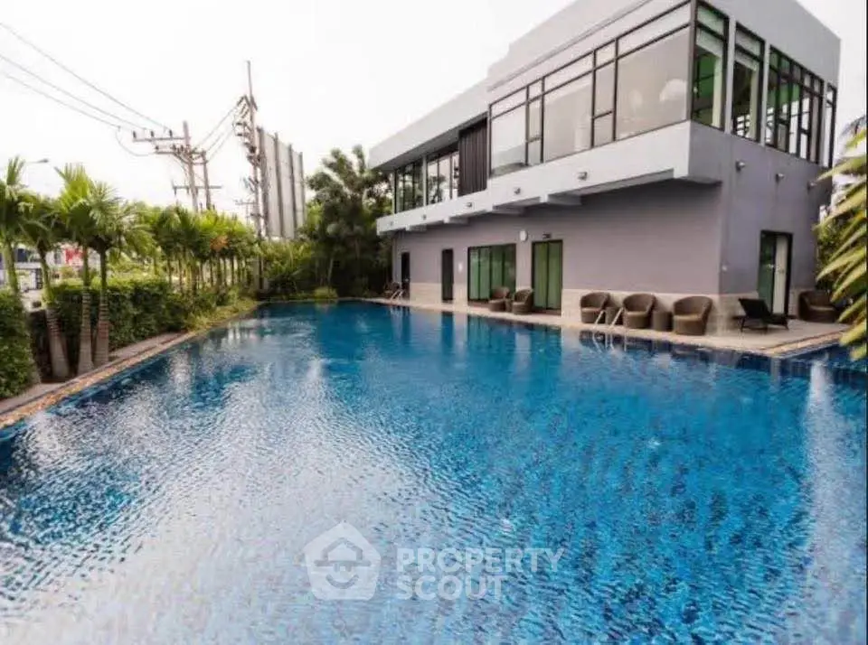 Luxurious modern building with a stunning outdoor pool and lush greenery, perfect for relaxation and leisure.