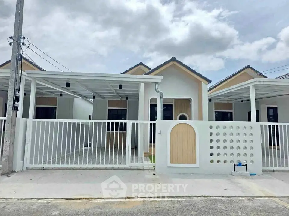 Charming modern single-story house with a gated front yard and carport, perfect for family living.