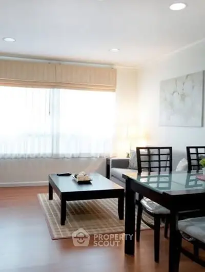 Bright and inviting living room with modern furniture and large window.