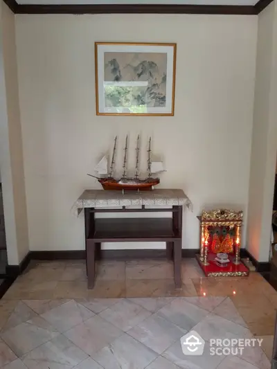 Elegant home interior with decorative ship model and framed artwork