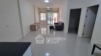 Spacious living room with modern furniture and large windows for natural light.
