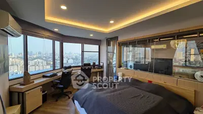 Luxurious bedroom with panoramic city views and modern workspace