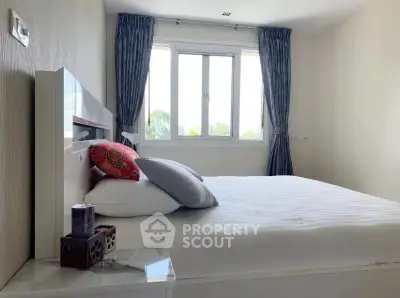 Bright and cozy bedroom with large window and elegant decor