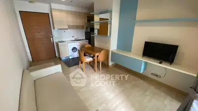 Modern apartment interior with compact kitchen and cozy living area